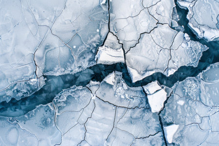 From above, the frozen river reveals intricate cracked ice patterns, photography captures the cool blues and whitesの素材