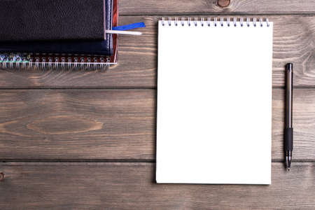 Notepad with a pen on the background of a brown wooden table. use of Wallpaper for education, business Photos.の写真素材