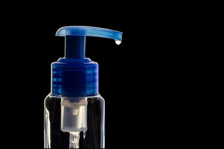 Hand sanitizer. Antibacterial gel for disinfecting hands. Protection from all viruses and bacteria. Sanitizer bottle with pump on black background.の写真素材