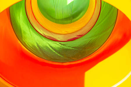 Background. The tunnel is visible from the inside in different colors. Children's slide inside. For...
