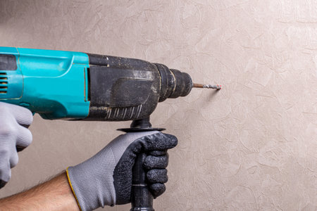 hands holding electric drill in the room, interior design concept and home renovation DIY conceptの写真素材