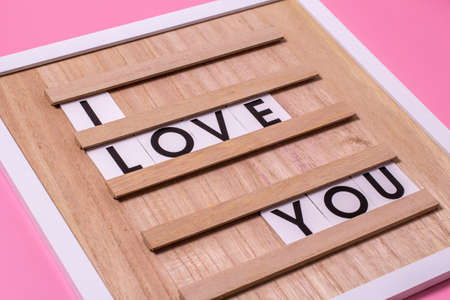 I miss you, on the board lying on a pink background. Love and Relationships quote board