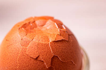 a broken boiled egg with cracks in the walls. cooking a boiled egg for breakfast.