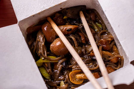chinese food buckwheat noodles with mushrooms close-up. Open paper boxの写真素材