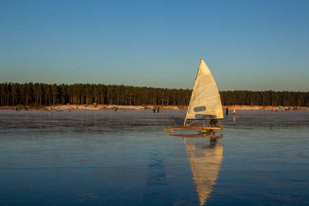 people ride and have fun on the frozen winter lake. winter entertainmentの写真素材
