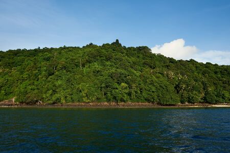 Boat trip in tropical sea to remote islands on the horizon