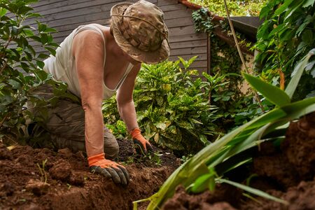 Senior woman workingon the ground in the garden