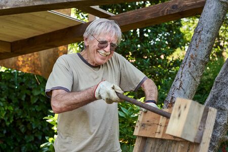 Active senior man in retirement working on the backyard, smilingの写真素材