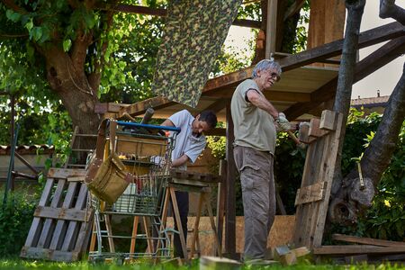 Active senior men working on the backyardの写真素材