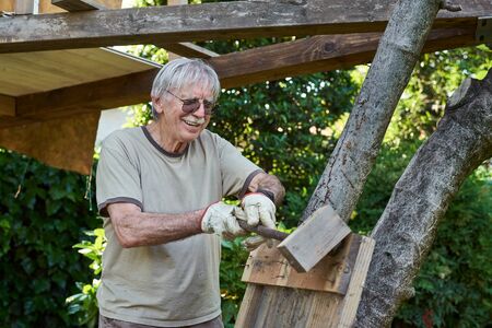 Active senior man in retirement working on the backyard, smilingの写真素材