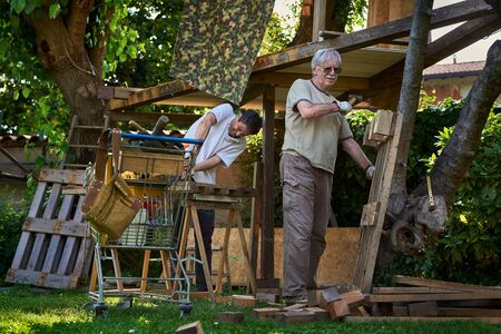 Active senior men working on the backyardの写真素材