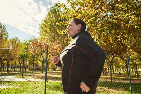 Active senior woman doing healthy exercises outdoors. Joggingの写真素材