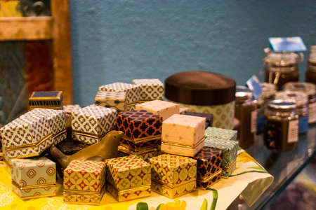 Different little boxes for chocolate pralines on top of showcase in storeの写真素材