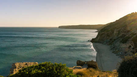 Coastline at Praia da Figueira from above the cliff with view at the beach below during sunset, Figueira, Portugalの写真素材