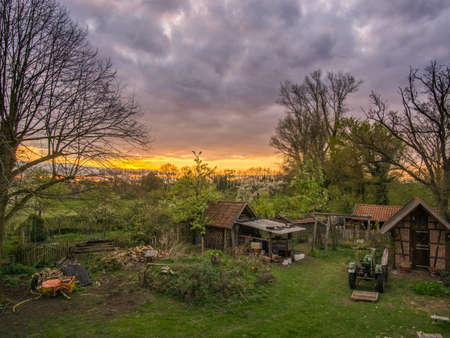 Beautiful farm with brick and truss buildings at eveningの写真素材