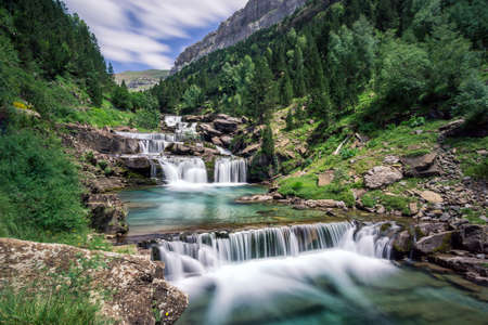 long exposure of Gradas De Soaso waterfall at Arazas river during summer, Ordesa National Park, Huesca, Spainの写真素材