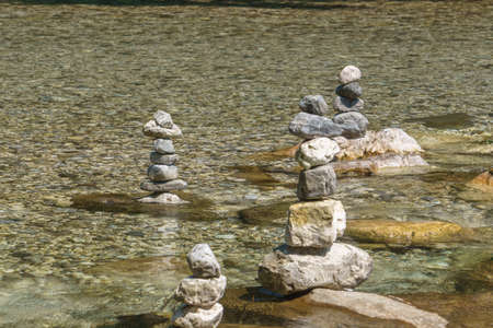 Stones build in tower in balance on top each in river