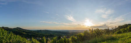 Panorama of golden sunset over beautiful landscape with the wine fields of the Black Forest, Sasbachwalden, Germanyの写真素材