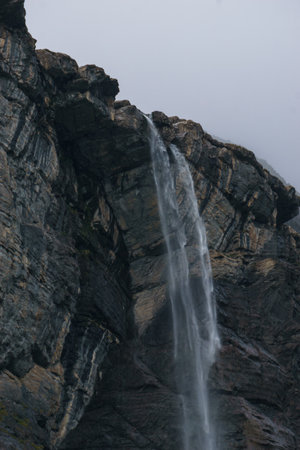 Detail of big waterfall of Gavarnie at massive high rock wall formation in Pyrenees Mountains,...