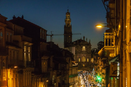Street view of Iconic church and tower of Clerigos at illuminated night, Porto, Portugalの写真素材