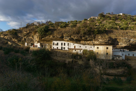 White house at typical Andalusian village in beautiful sunlight, Setenil de las Bodegas, Andalusia, Spainの写真素材