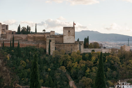 The fortress of Alhambra on a hill top seen from the quarter Albaicin with mountains of Sierra Nevada in background, Granada, Andalusia, Spainの写真素材