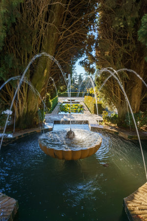 Beautiful green garden with fountain at Generalife of Alhambra, Granada, Andalusia, Spainの写真素材