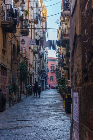 Typical townscape of dark narrow streets and alleys in the city of Naples, Campania, Italyの写真素材