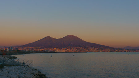 Mount Vesuvius over the city of Naples during golden hour at sunset, Naples, Campania, Italy