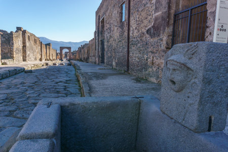 Roman street on a sunny day through the Ruins of Pompeii, Campania, Italyの写真素材