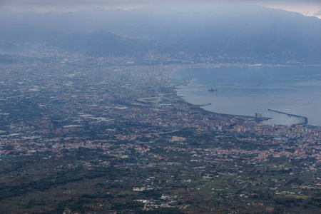 View from the top of Mount Vesuvius down to the city of Pompeii on a hazy winter day, Naples, Campania, Italyの写真素材