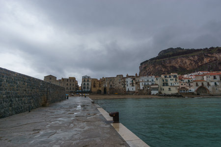 Townscape of the port of Cefalu on a cloudy rainy day, Cefalu, Sicily, Italyの写真素材