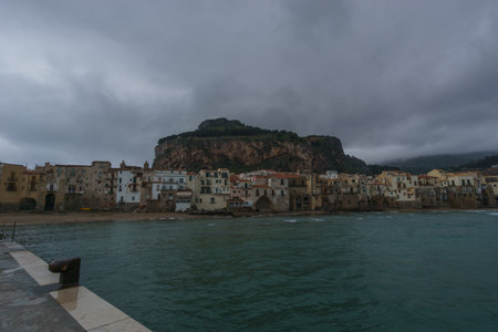 Townscape of the port of Cefalu on a cloudy rainy day, Cefalu, Sicily, Italyの写真素材