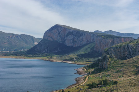View over mediterranean coastline with bay of sea water at Nature Park Monte Cofano with beautiful green vegetation, San Vito Lo Capo, Sicily, Italyの写真素材