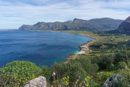 View over mediterranean coastline with bay of sea water at Nature Park Monte Cofano with beautiful green vegetation, San Vito Lo Capo, Sicily, Italyの写真素材