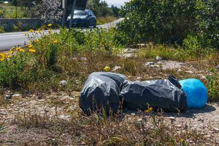 Waste of plastic bags dumped at roadside in Sicily, Italyの写真素材