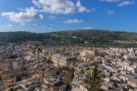 Cityscape of small town in mountains on a sunny spring day, Scicli, Sicily, Italyの写真素材