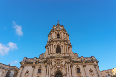 Facade of the beautiful Sicilian baroque church Duomo of San Giorgio on a sunny day, Modica, Sicily, Italyの写真素材