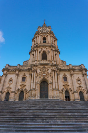 Facade of the beautiful Sicilian baroque church Duomo of San Giorgio on a sunny day, Modica, Sicily, Italyの写真素材