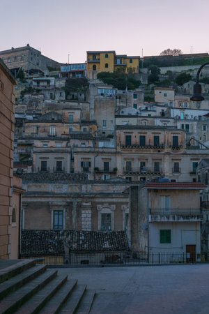 Townscape of the houses in the city during evening twilight, Modica, Sicily, Italyの写真素材