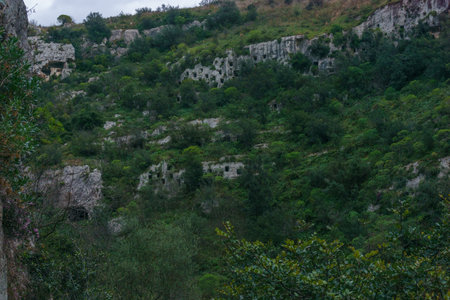 The rock-cut tombs of the Pantalica Necropolis a Prehistoric cemetery at the nature reserve Pantalica, Siracusa, Sicily, Italyの写真素材