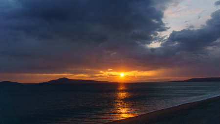 Atmospheric dark sunset in Neapoli with sun rays shining through clouds in the sky, Neapoli, Laconia, Peloponnese, Greeceの写真素材