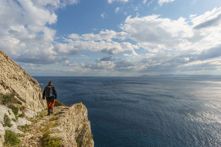 Hiking path with tourist at beautiful rocky landscape of mediterranean coastline at Cape Maleas, Laconia, Peloponnese, Greeceの写真素材