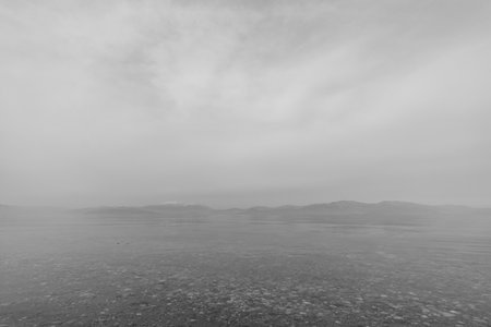 Dreamy fog over Corinthian Gulf with calm water on a tranquil peaceful morning, Corinthia, Peloponnese, Greeceの写真素材