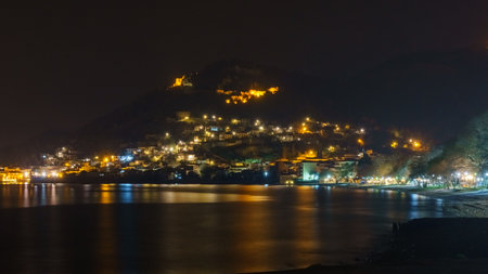 Panoramic view of the illuminated port of Nafpaktos at night with castle on the hill, Aetolia-Acarnania, Greeceの写真素材