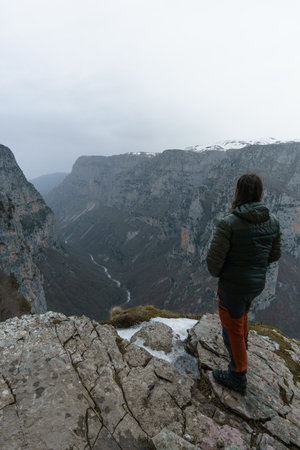 View of the impressive Vikos gorge in the Zagoria region at Pindus Mountains on a foggy winter day...