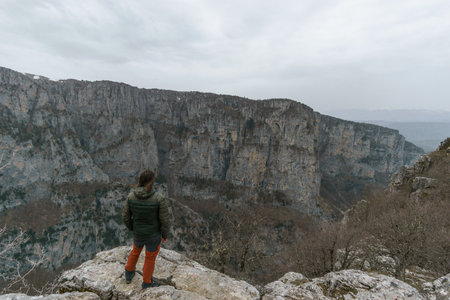 View of the impressive Vikos gorge in the Zagoria region at Pindus Mountains on a foggy winter day...