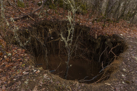 Sinkhole in the forest at the Vikos gorge in the Zagoria region at Pindus Mountains, Epirus, Greece