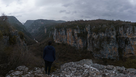 Panoramic view of the impressive Vikos gorge in the Zagoria region at Pindus Mountains on a dark...
