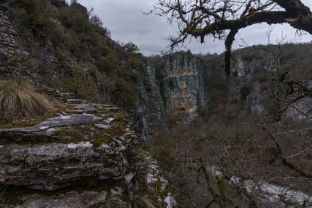 Rock formation at the impressive Vikos gorge in the Zagoria region at Pindus Mountains on a dark...